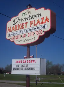 Tall Downtown Market Plaza electric pole sign