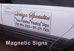 Removable Designing Specialties magnetic sign on a white vehicle door